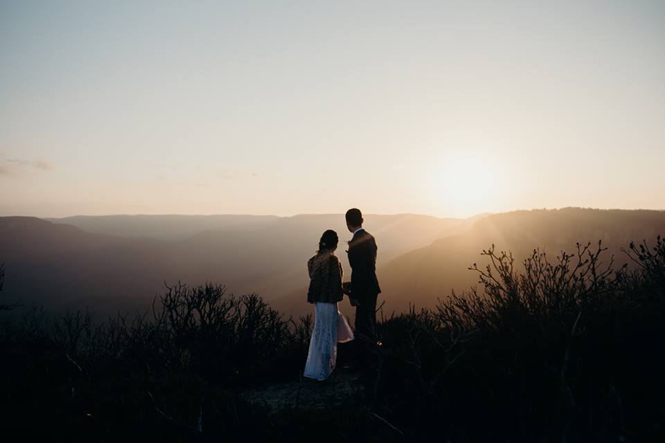 Couple on cliff top at sunset