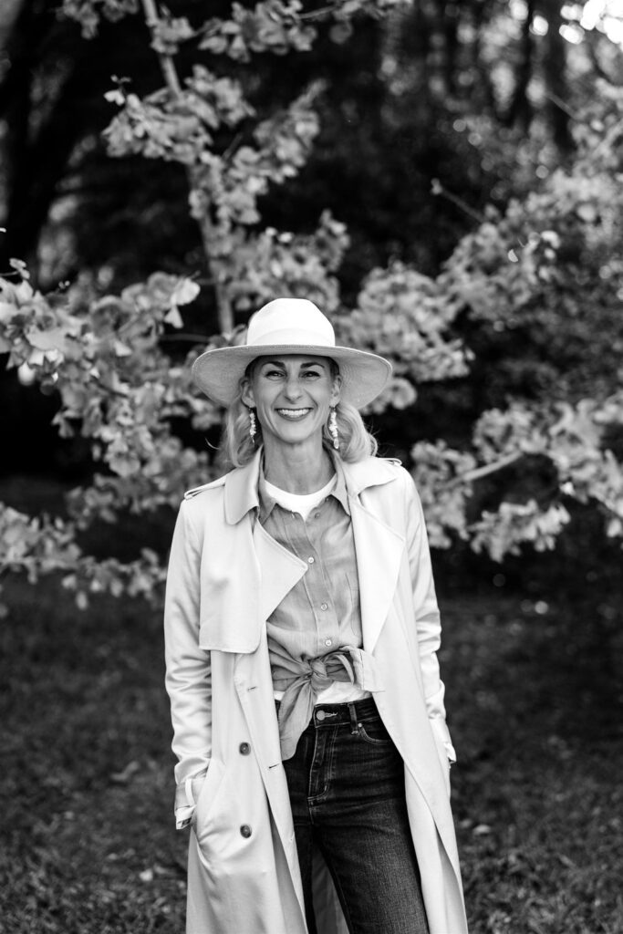 Wollongong and South Coast Marriage Celebrant Jacq Majer black and white portrait with coat and hat