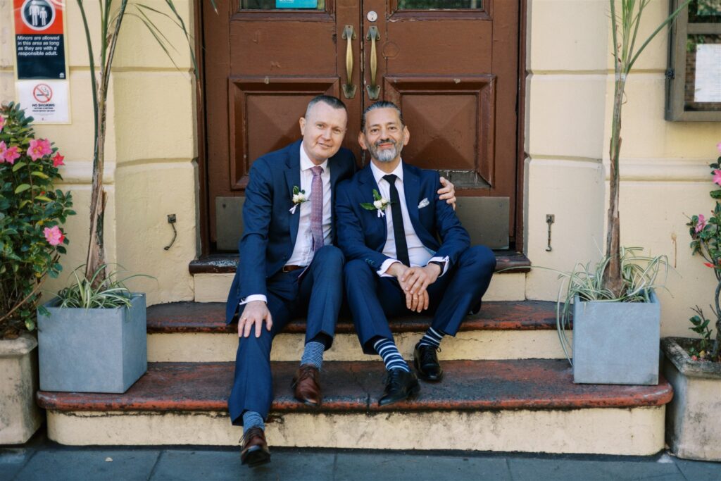 John and Jeff wedding portrait sitting on pub steps in Sydney